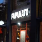 Papanato Sagrada Familia infographic showing menu items, prices, pros and cons, and 2026 review rating near Barcelona landmark