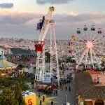 Infographic showing Parque de Atracciones Tibidabo in Barcelona with top rides, ticket prices, transport guide, and panoramic mountain views over the city at sunset.