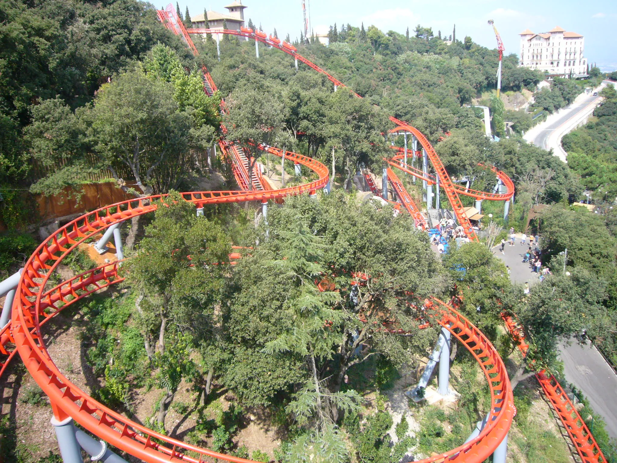 Tibidabo Amusement Park in Barcelona at sunset featuring the Avió airplane ride, Ferris wheel, panoramic skyline views, vintage attractions, and Temple of the Sacred Heart.