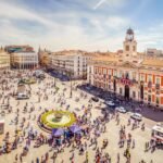 Infographic showing weather in Spain in February 2026, including temperatures in Canary Islands, southern Spain, Madrid, and northern Spain, with travel tips for winter sun, skiing, beaches, and cultural cities.